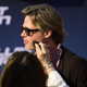 Brad Pitt gets his skin wiped off as he poses for a photo on the red carpet for a preview of the film “Bullet Train” in Berlin on July 19, 2022.